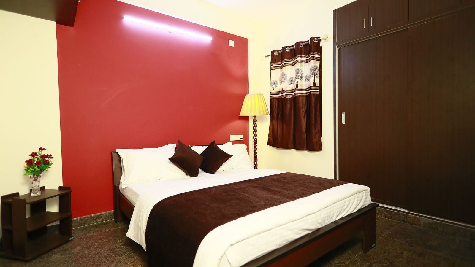 A queen size bed in a room at Tranquil ABS Orchid Serviced Apartments