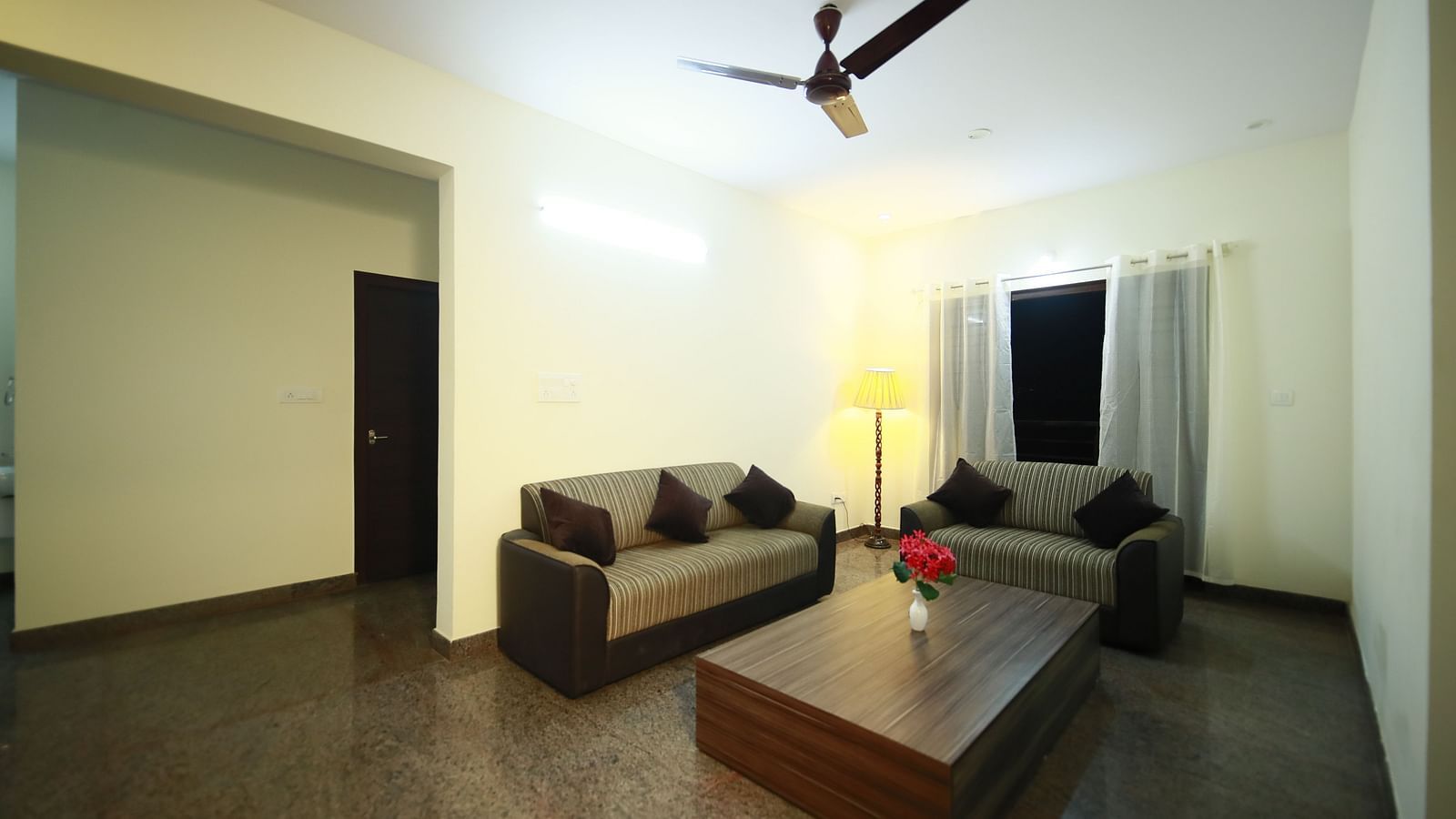 Living area with sofa seating and a coffee table at Tranquil ABS Orchid Serviced Apartments.