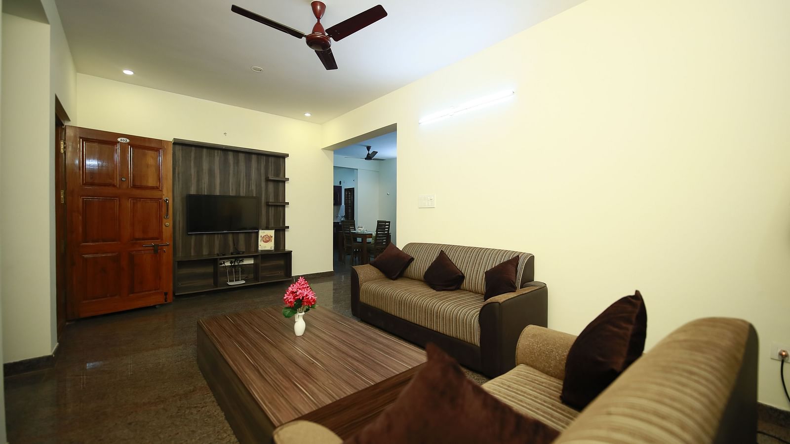 Living area with sofa seating and a coffee table at Tranquil ABS Orchid Serviced Apartments.