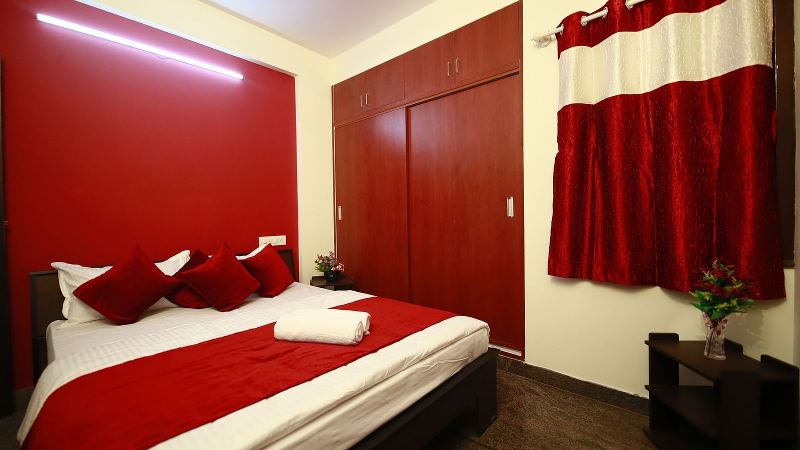 A queen size bed in a room at Tranquil ABS Orchid Serviced Apartments