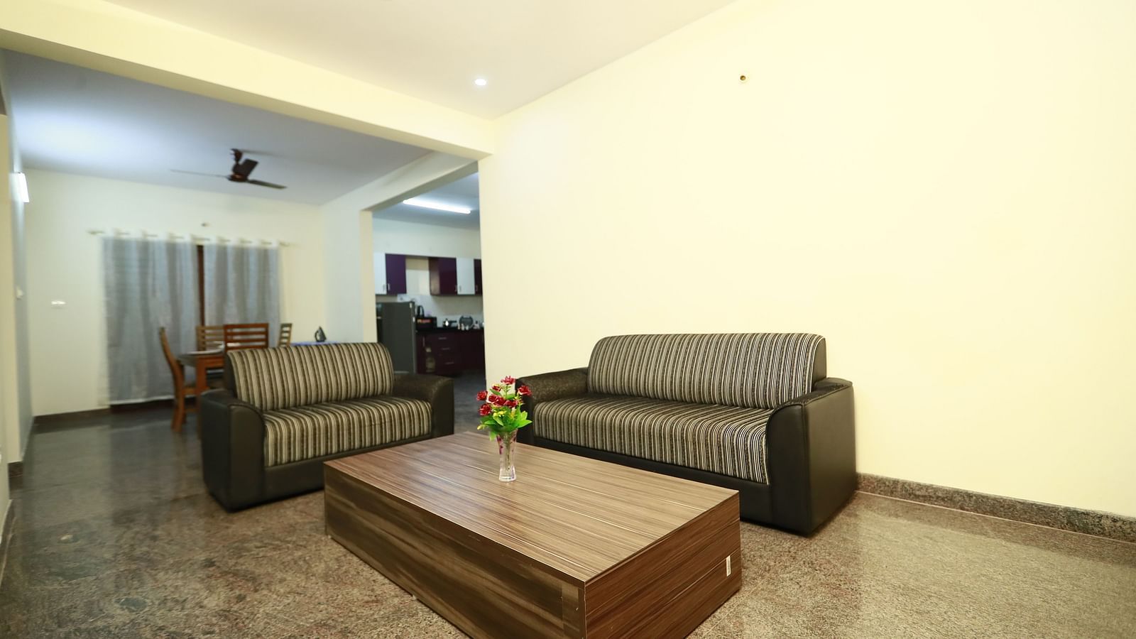 Living area with sofa seating and a coffee table at Tranquil ABS Orchid Serviced Apartments.