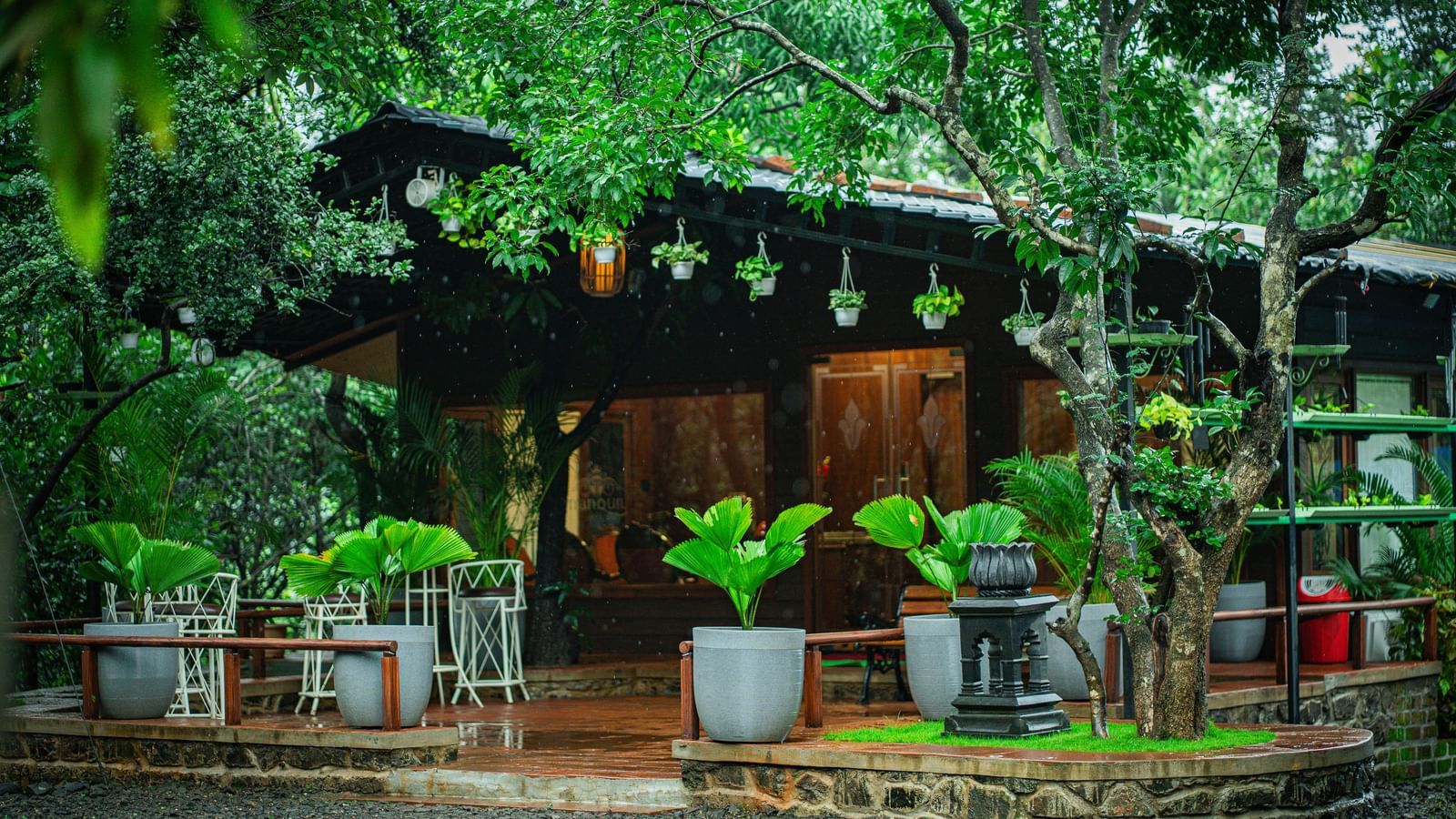 A wooden building with a tiled roof, surrounded by numerous potted plants - Tranquil Piedmont Estates & Resort