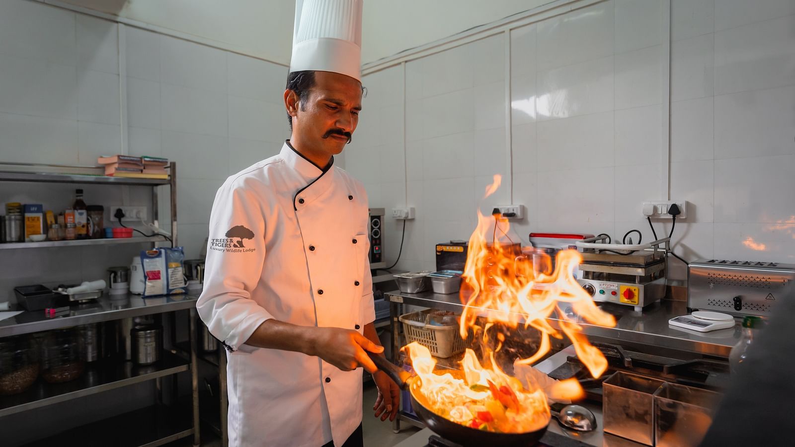 A chef cooking in the kitchen at Trees N Tigers, Tadoba.