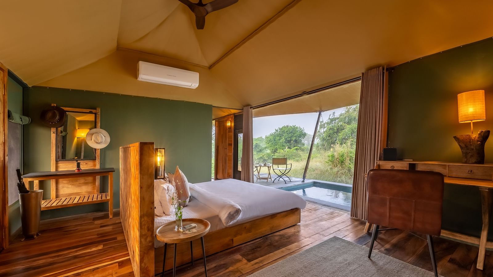 An interior of a room with double bed at Trees N Tigers, Tadoba.
