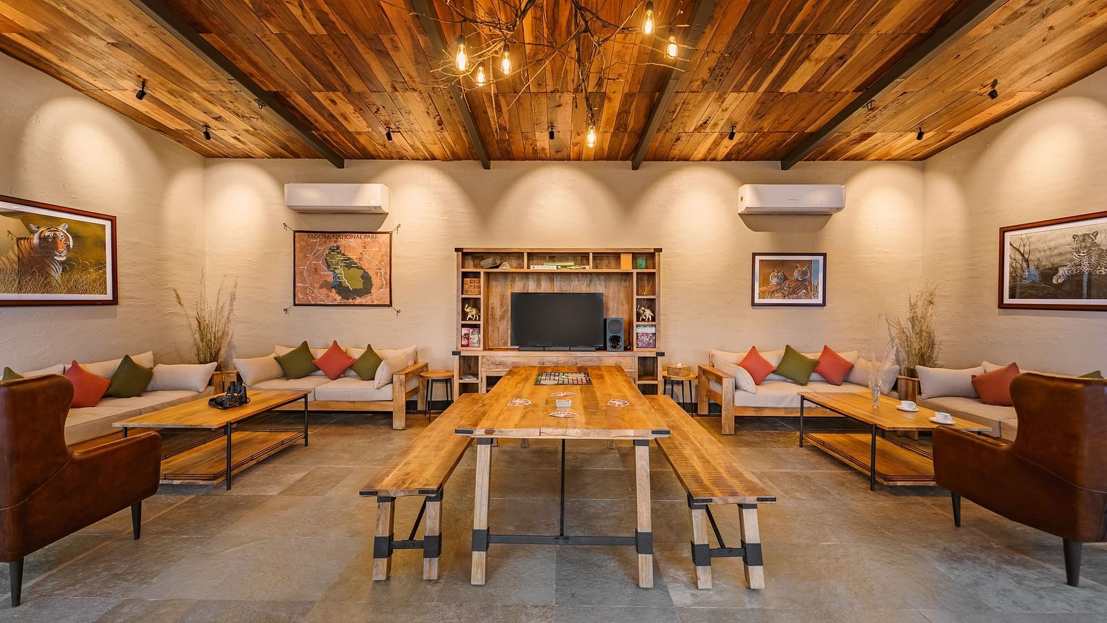 A room with centre table and sofas at Trees N Tigers, Tadoba.