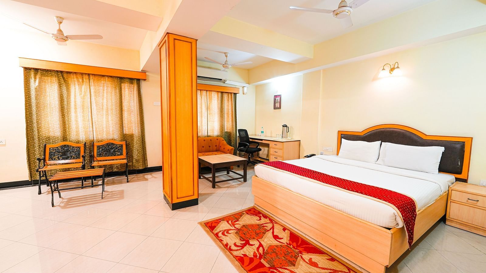 Room at Vasundhara Villa with a double bed and seating