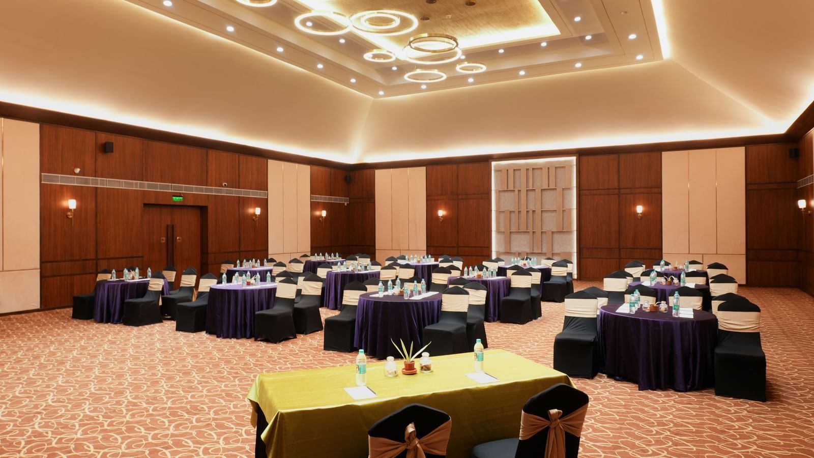 Om Ballroom in Vedic Village Spa Resort, featuring spacious seating and modern interiors. 