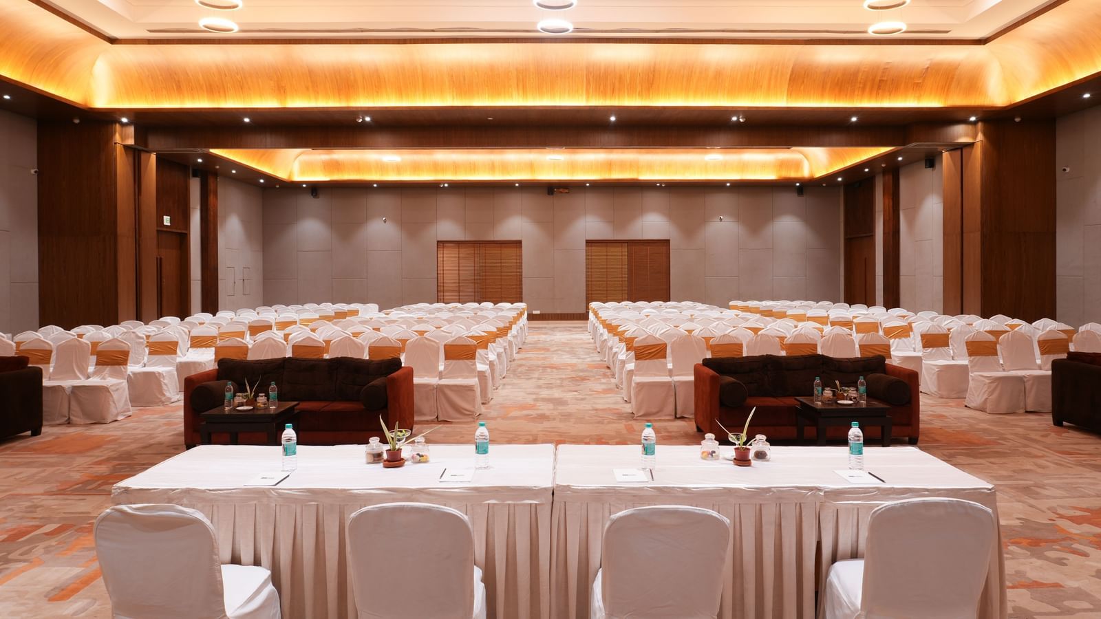 Conference room setup with U-shaped seating and elegant lighting in Utsav Convention Centre at Vedic Village Spa Resort.