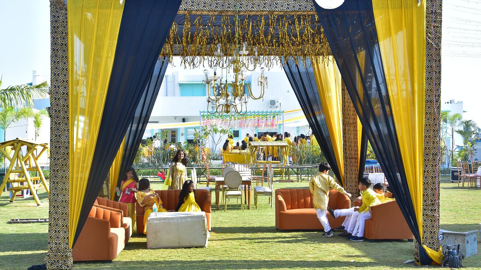 Outdoor seating lounge setup for sangeet night at Vedikant Resorts The Mallard Corbett with clear blue sky in the background.
