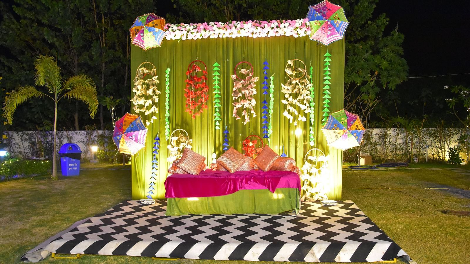 Vibrant mandap setup on a checkered rug at Vedikant Resorts The Mallard Corbett with night sky in the background.