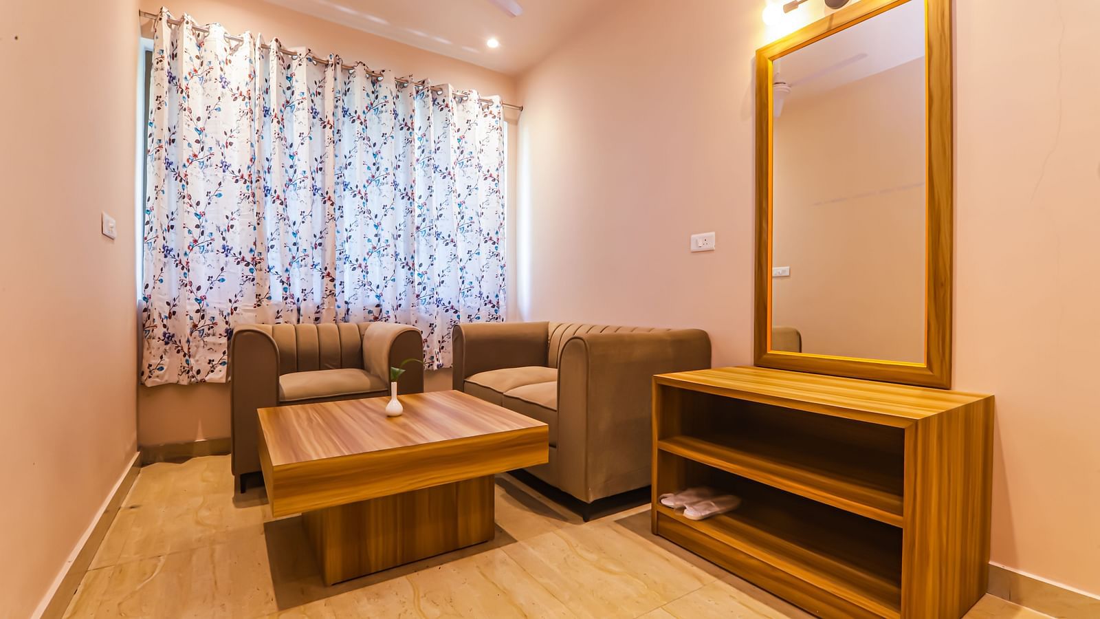 A well-furnished room at Vedikant Resorts The Mallard Corbett has a bed, seating, a mirror, and storage units.
