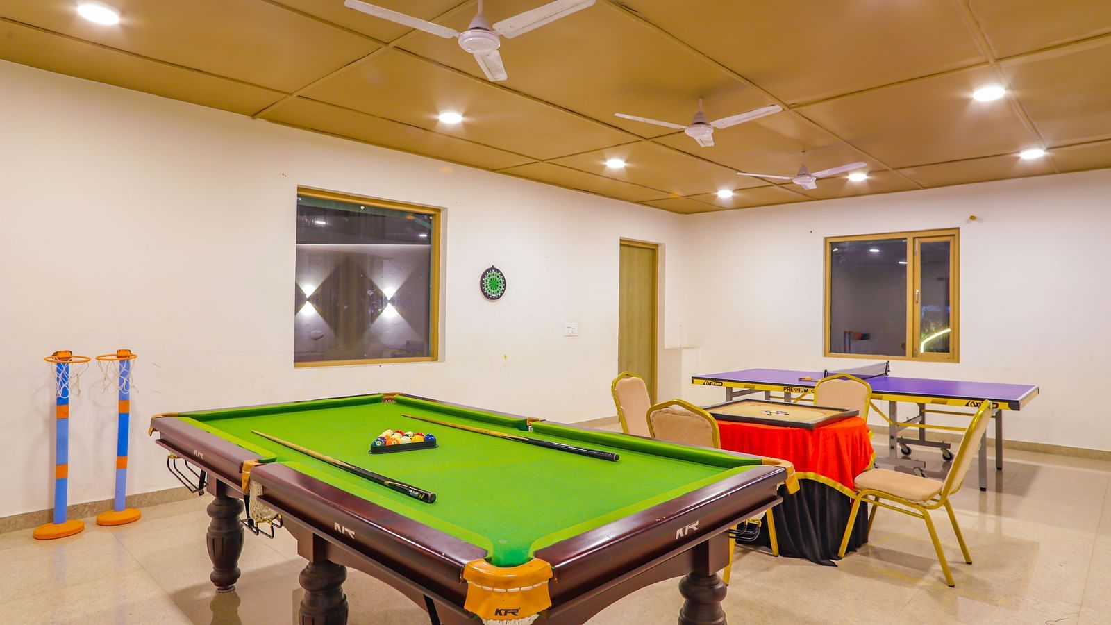 A game room at Vedikant Resorts The Mallard Corbett features a pool table, table tennis setup, and other games.