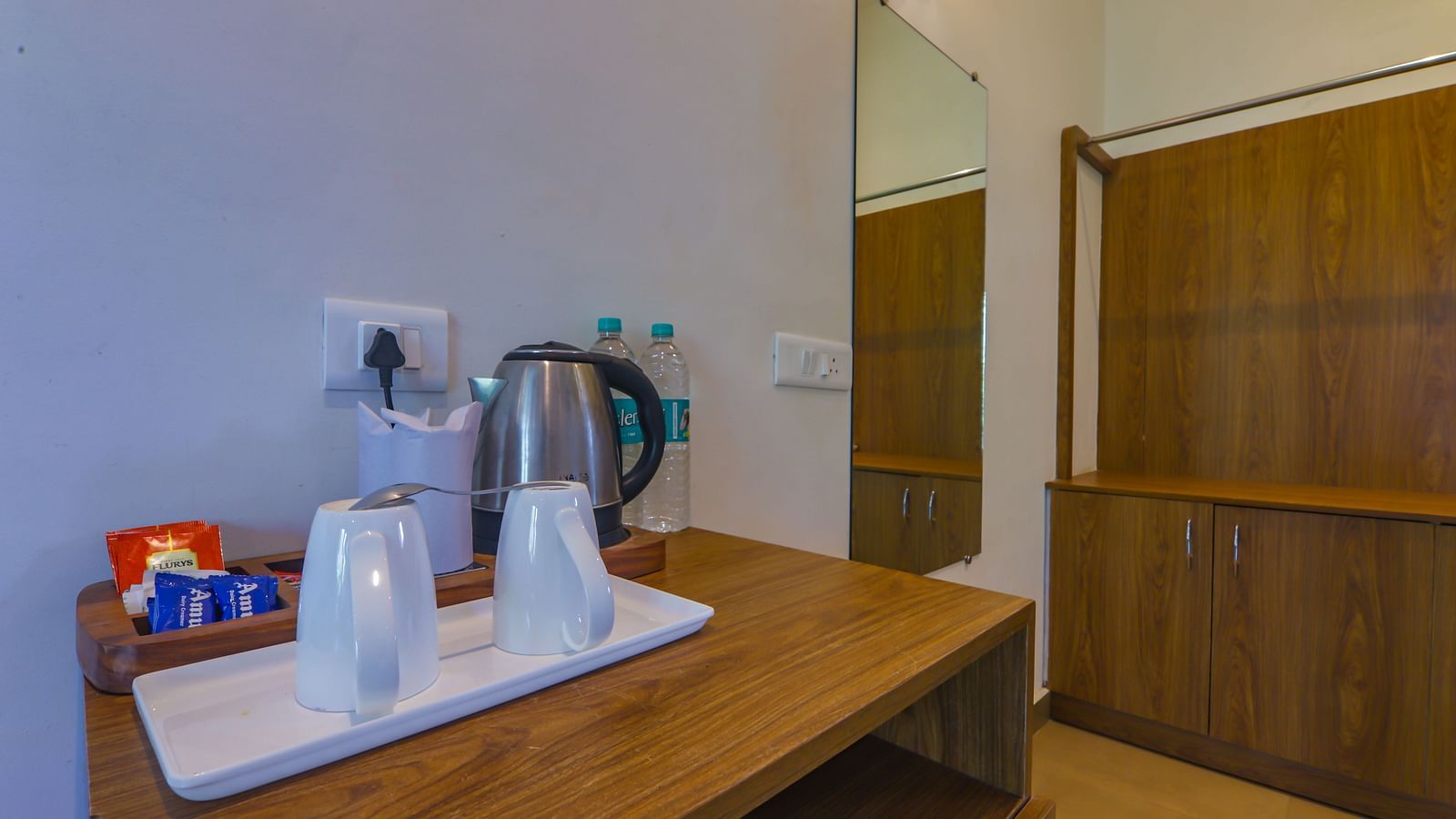 In-room tea and coffee station at Vedikant Resorts The Mallard Corbett with electric kettle, cups, and condiments.