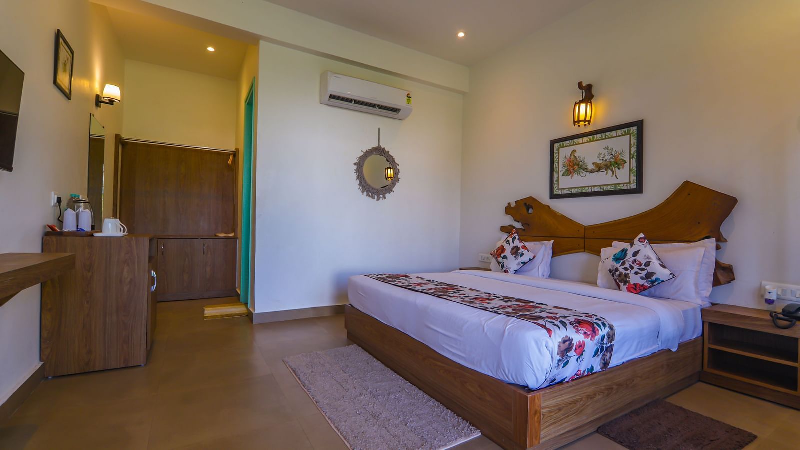 Room at Vedikant Resorts The Mallard Corbett with wooden flooring, modern furniture, bed, wardrobe, and attached bathroom area.