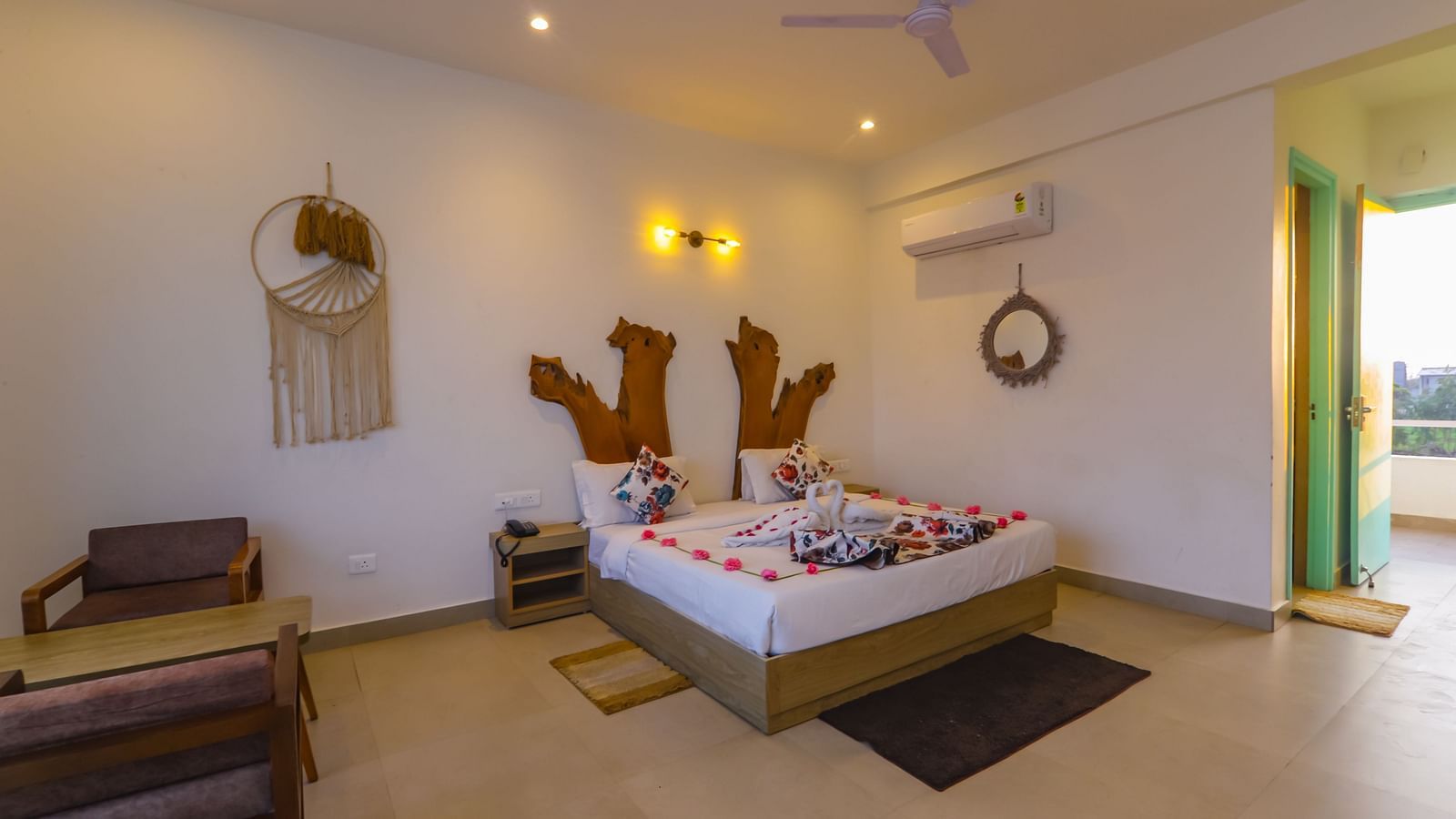 A bright bedroom at Vedikant Resorts The Mallard Corbett features a decorated bed and comfortable seating.