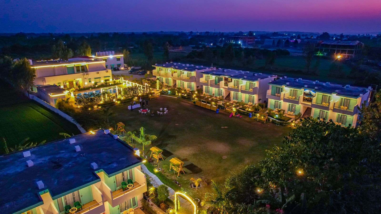 Night view of the illuminated resort complex, showcasing its layout and green surroundings.