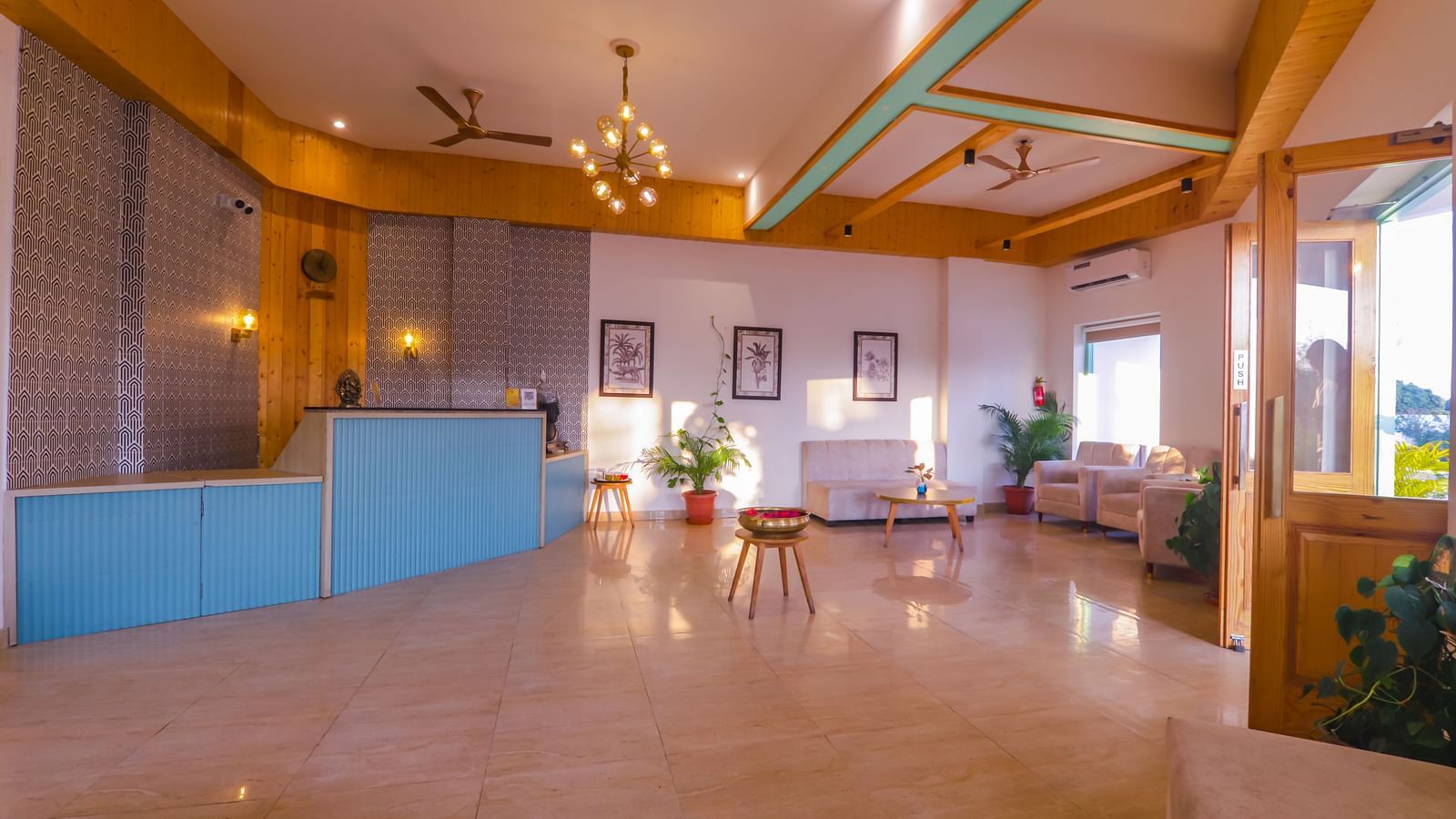 A spacious and well-lit lobby area at Vedikant Resorts The Mallard Corbett features tiled flooring and comfortable seating.