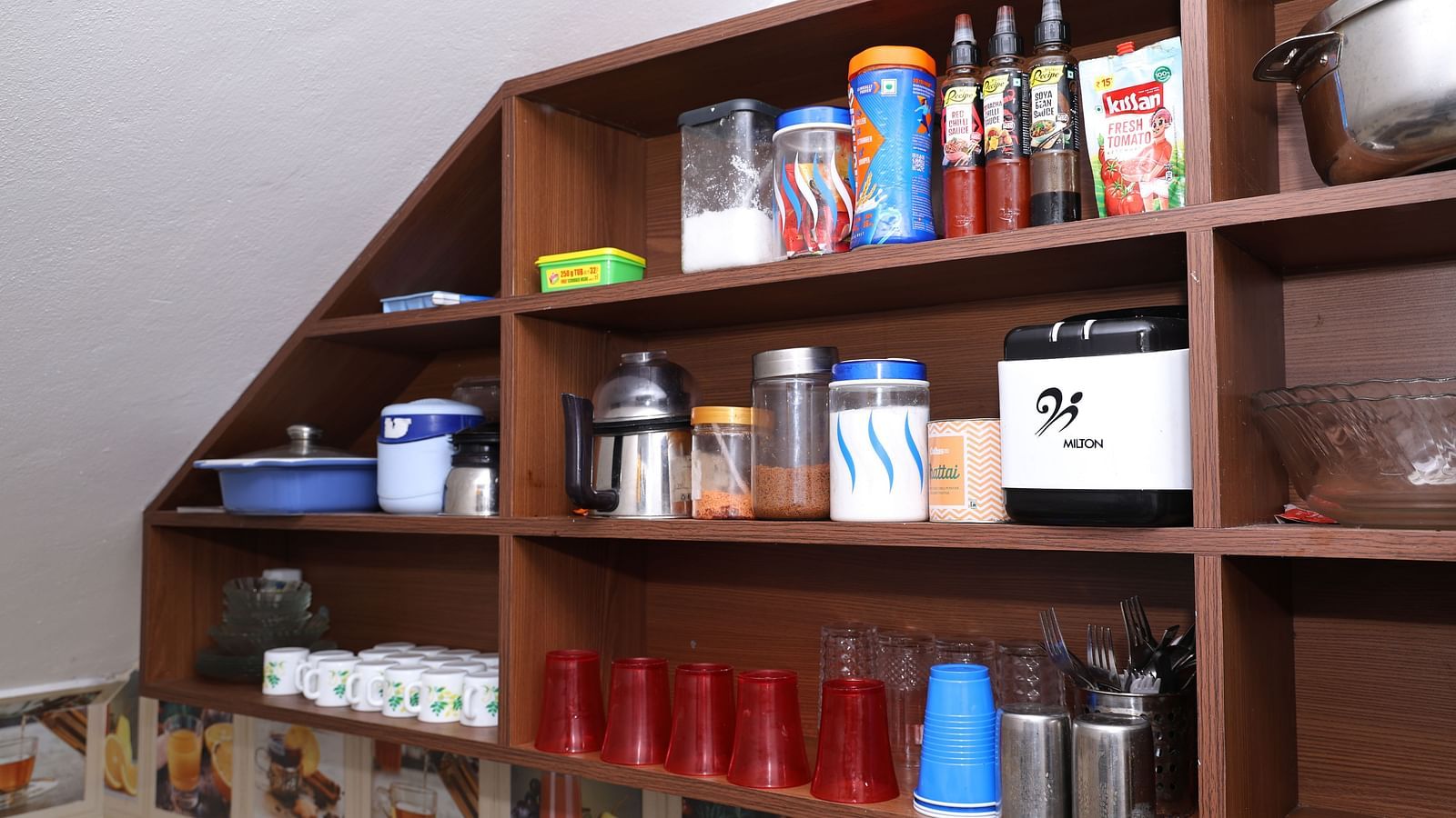 Image of a wooden shelf filled with cooking essentials at Villa Serenity Le Sejour, Pondicherry.