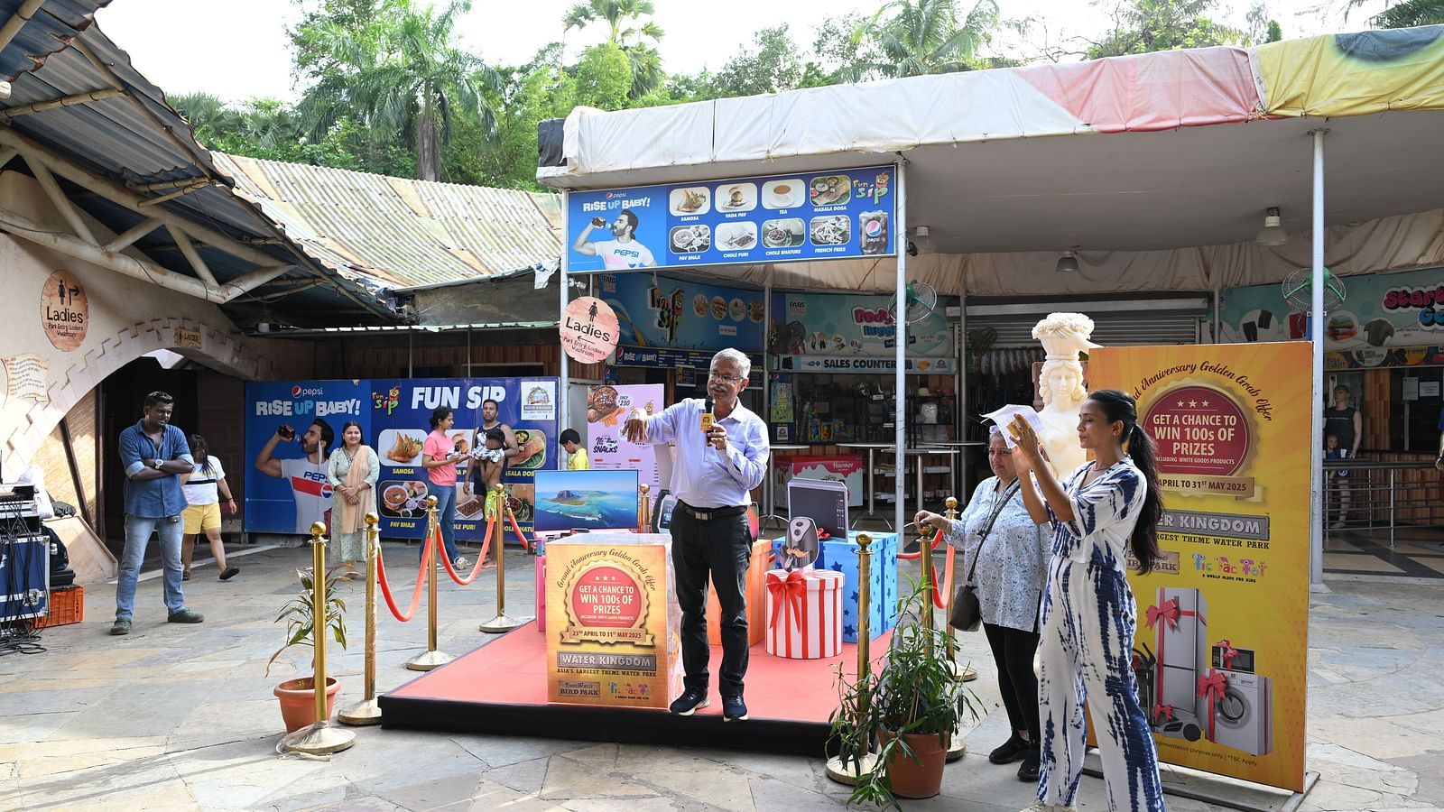 Stage view with event branding and speakers engaging the audience.