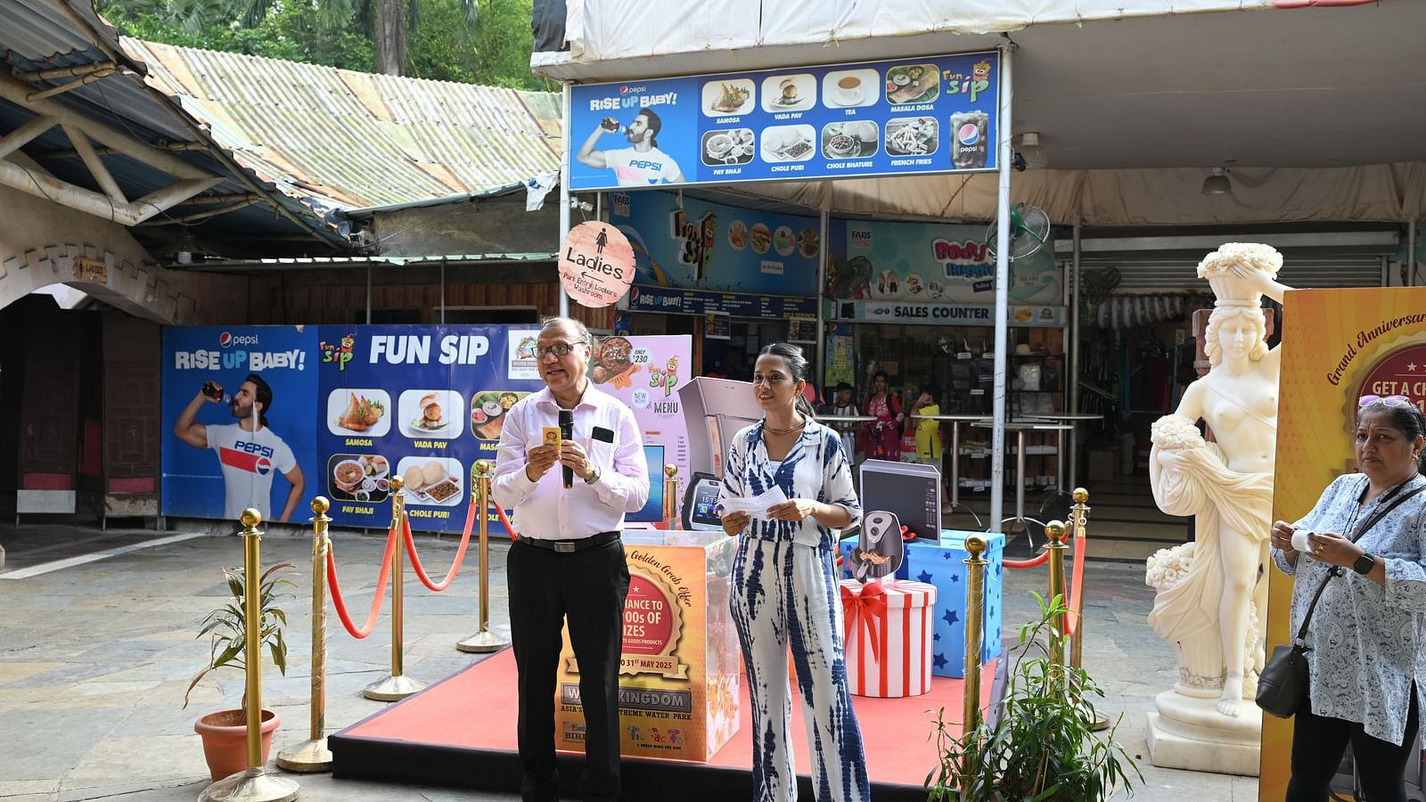 Host announcing the Golden Grab Celebration event at Water Kingdom.