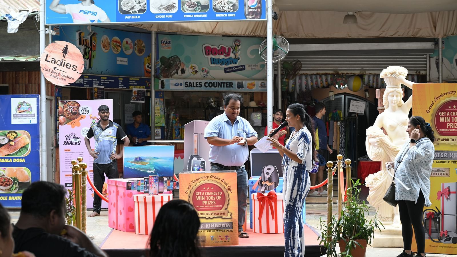 Stage view with event branding and speakers engaging the audience.