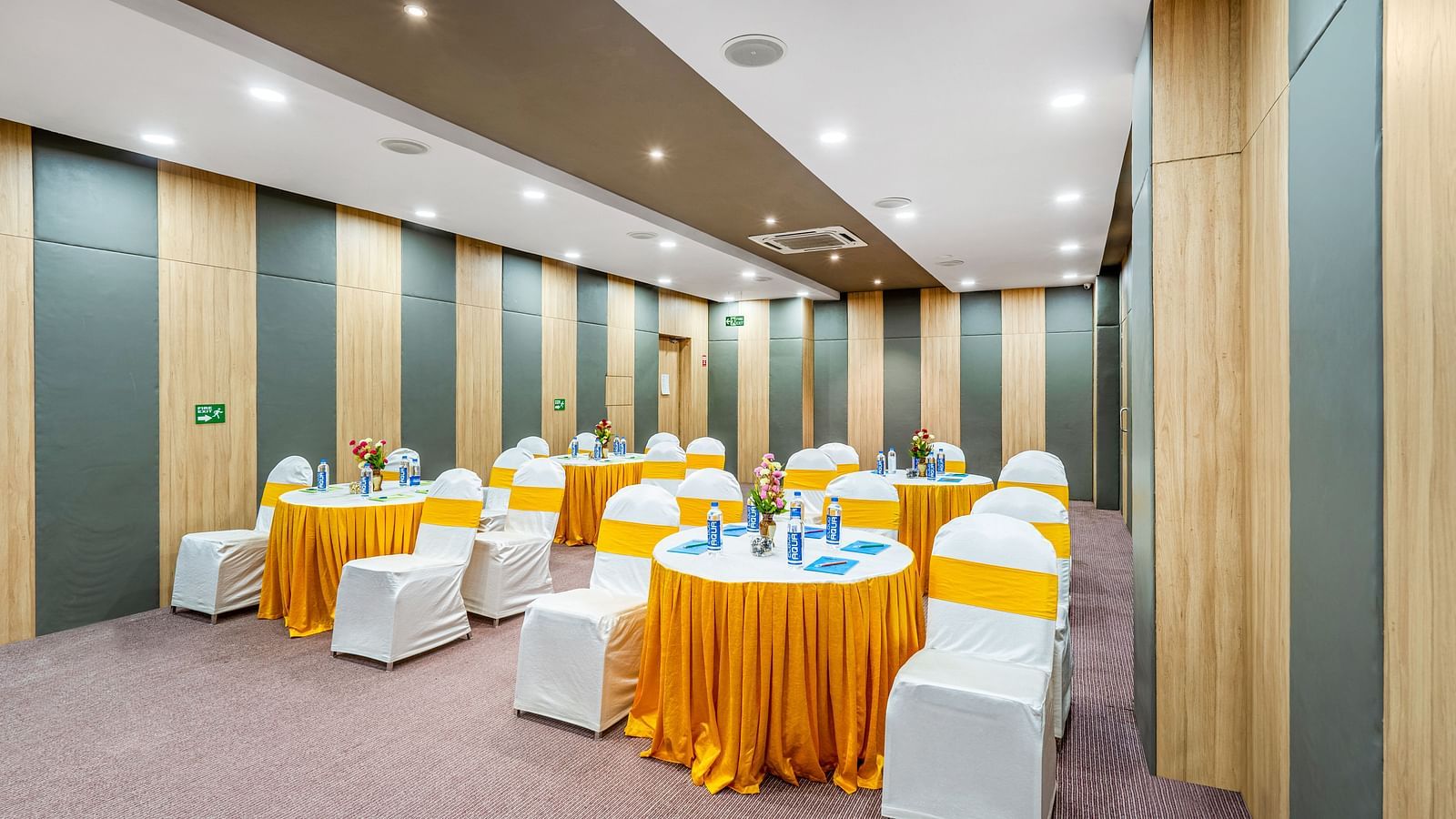A well-furnished conference room displaying a table and chair at Westside Hotel Hitech City