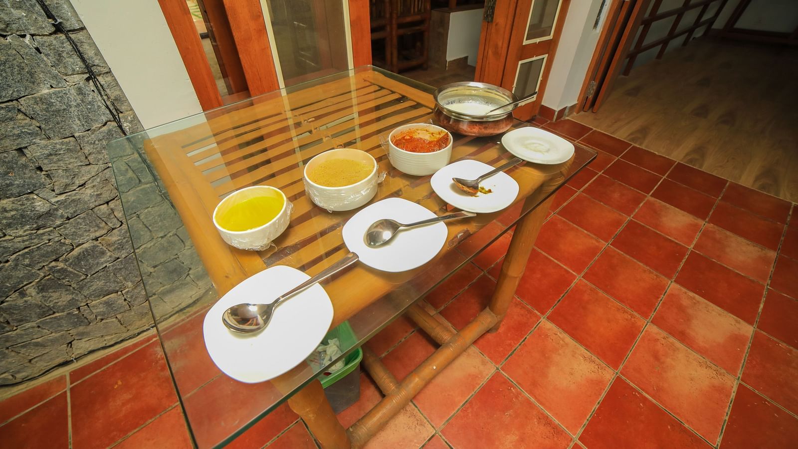 Image of a table filled with foods and crockeries at WOW Bison Woods.
