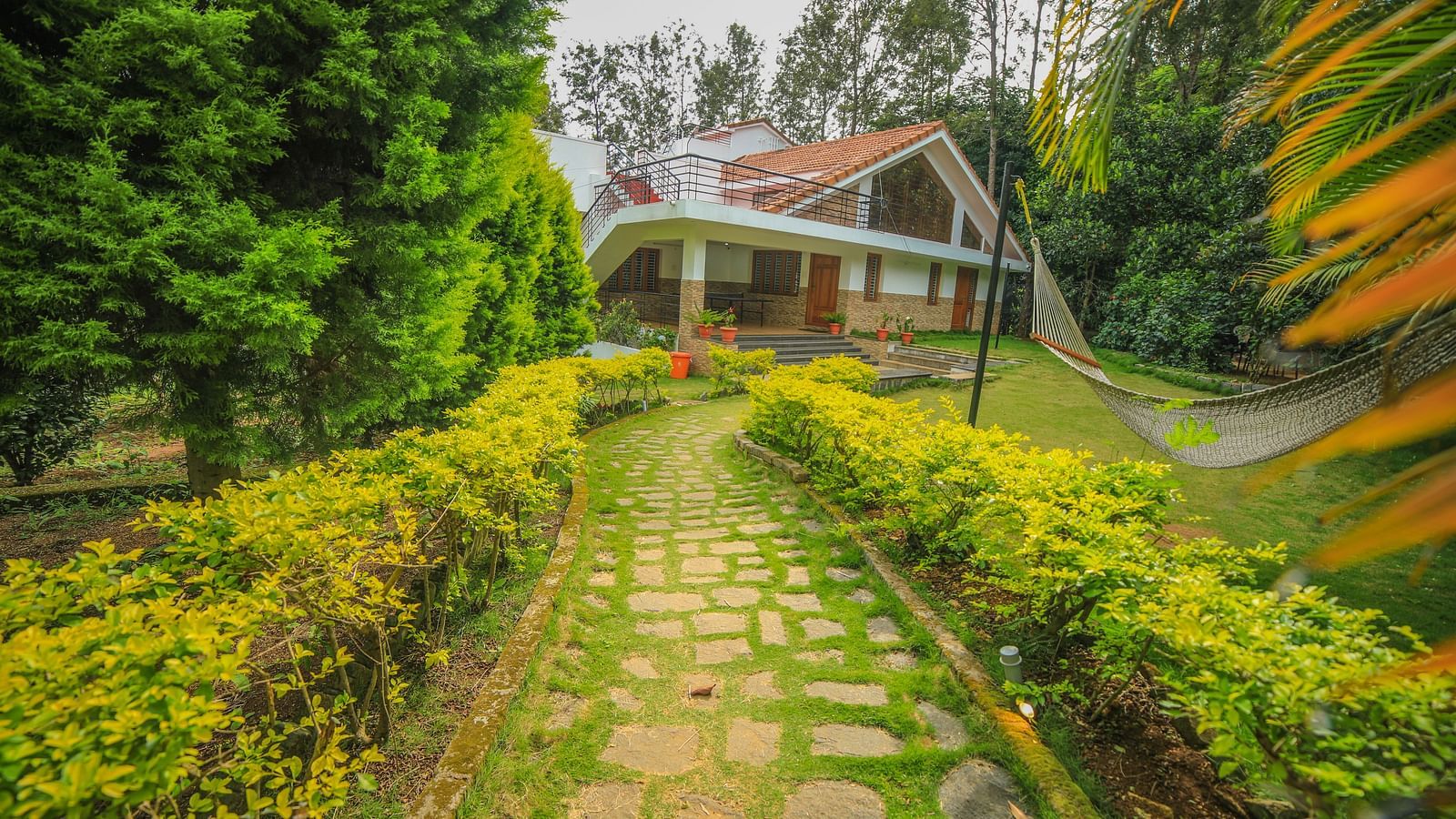 Facade of WOW Bungalow surrounded by plants and trees at WOW Bison Woods.
