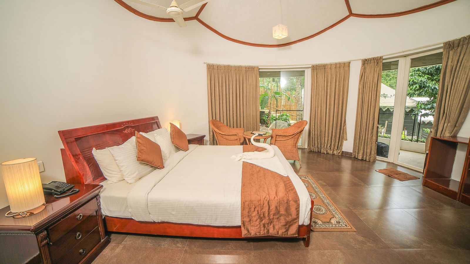 Side view of a room with a bed and a wooden tables beside it at WOW Bison Woods.