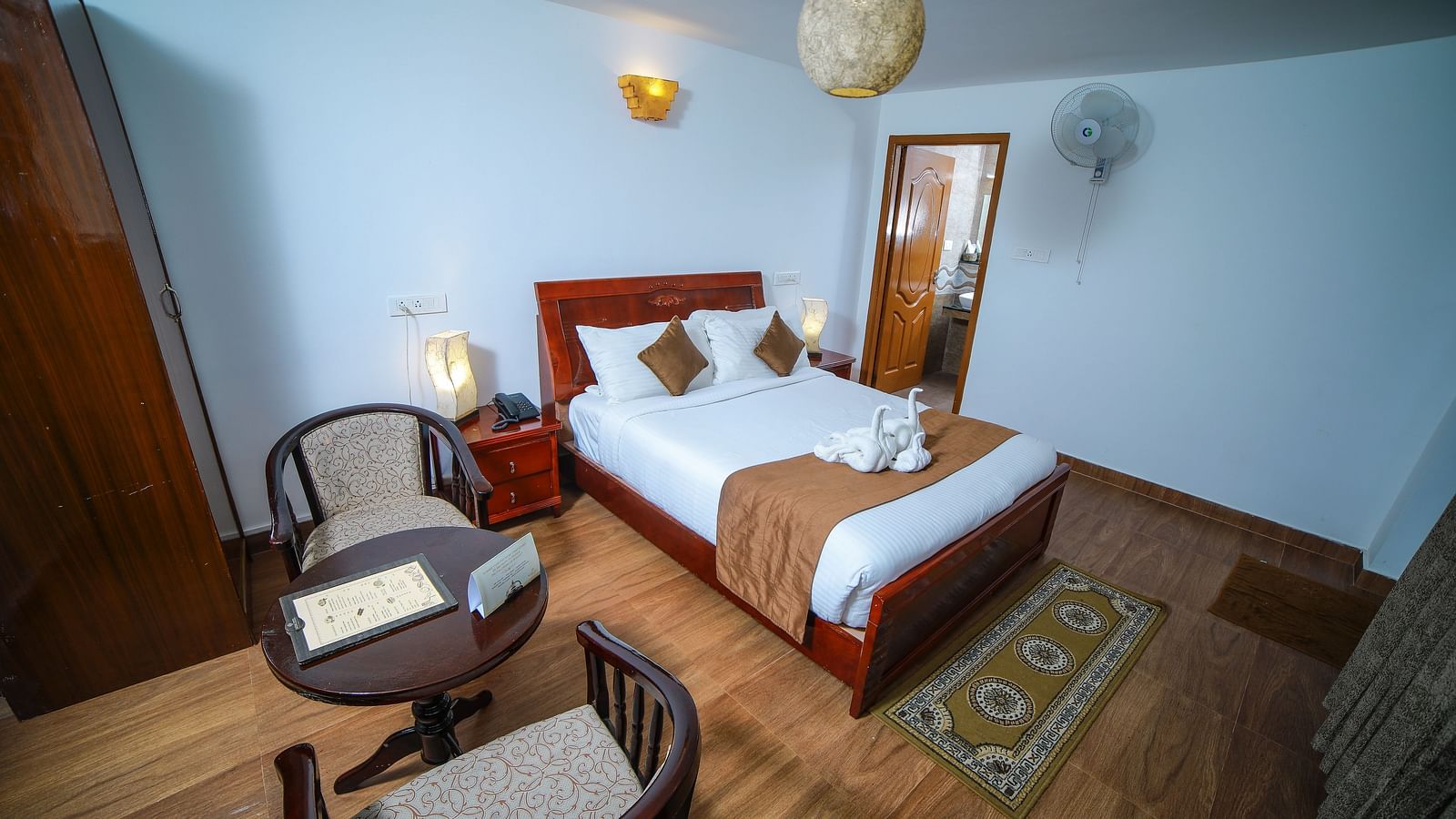 Image of a room with a bed a wooden table beside it at WOW Bison Woods.