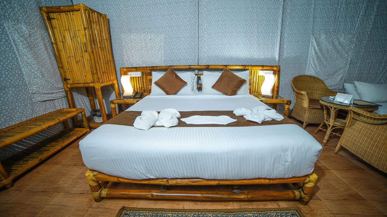 Image of a room with a bed and a wooden wardrobe on the side at WOW Bison Woods.