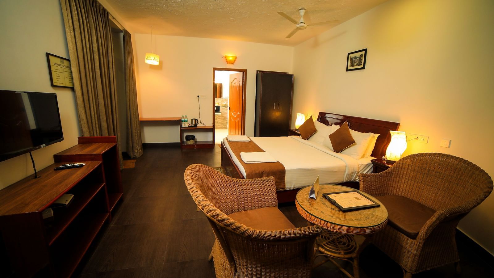 Image of a room with a bed, a television, and a seating area on the side at WOW Bison Woods.