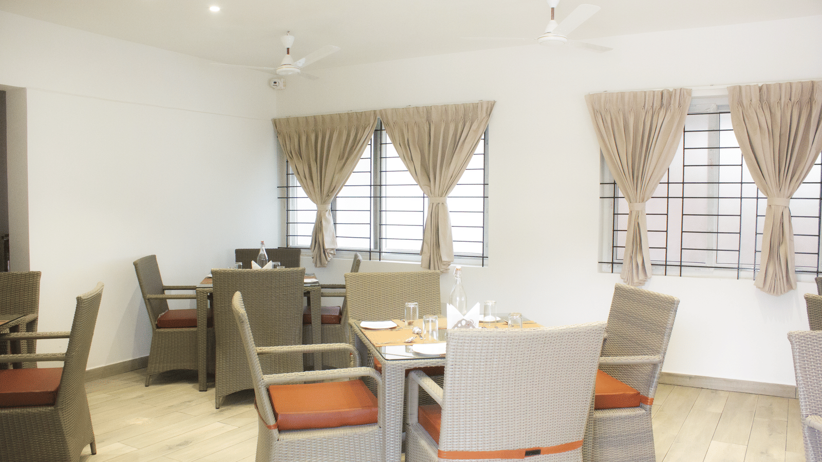A full-view shot of the Spice and Slice Restaurant with well-arranged dining tables at WOW Naturefull Resorts, Yercaud.