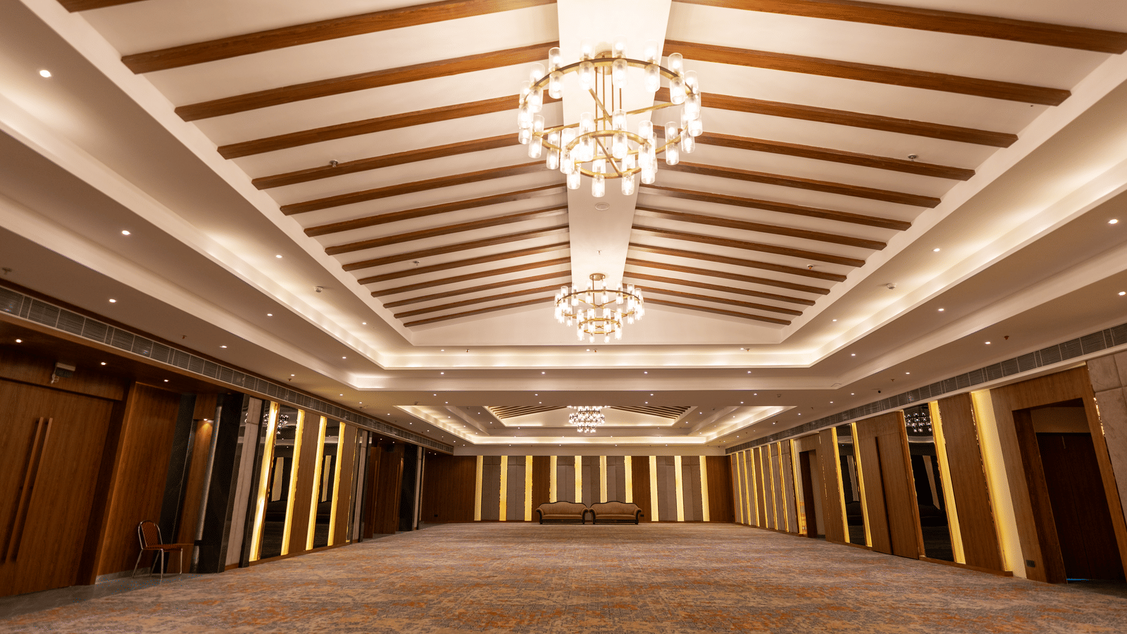 A large banquet hall at Wyndham Garden showcasing a detailed ceiling pattern and an ample event area.