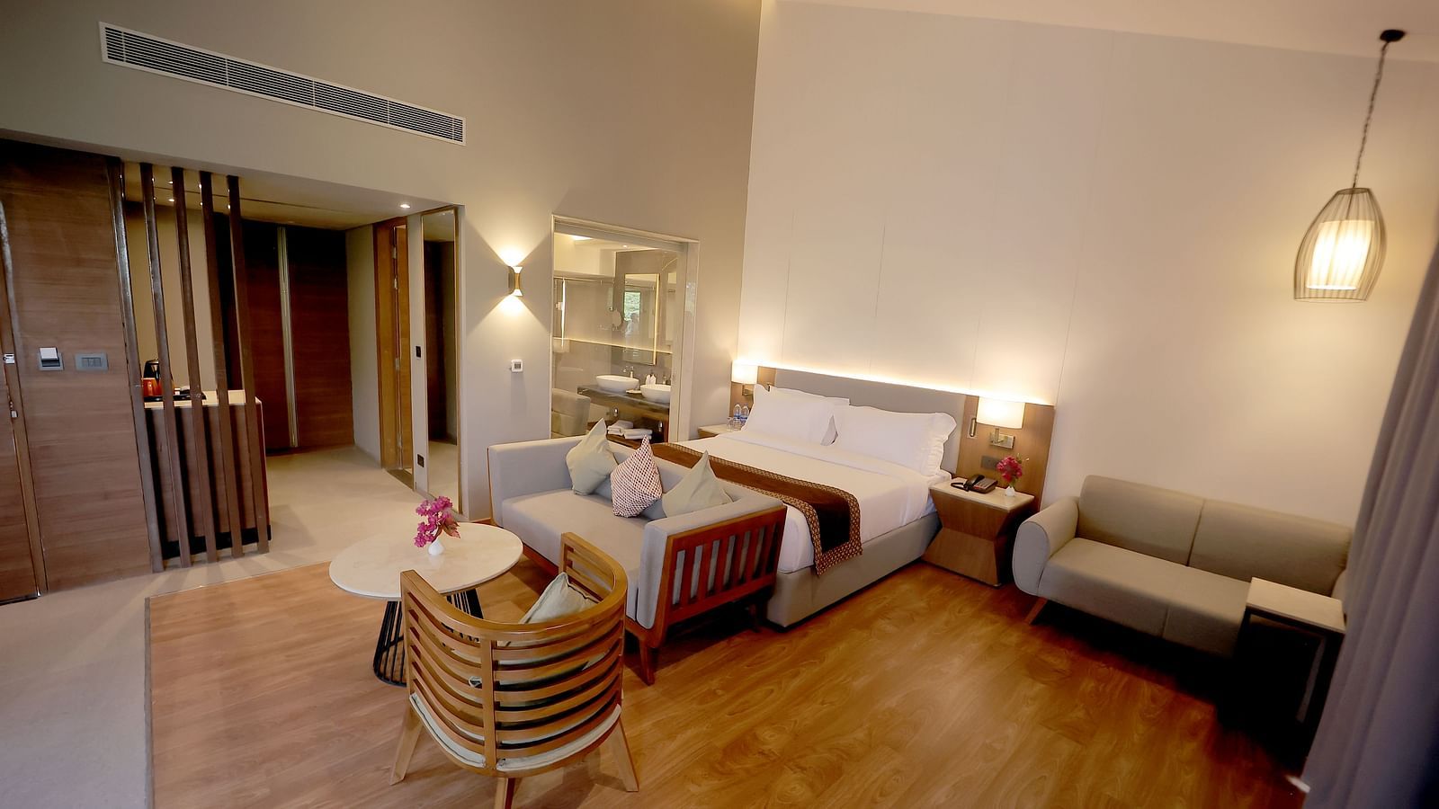 Room with wooden flooring, soft ambient lighting, and a welcoming seating corner at Wyndham Garden.