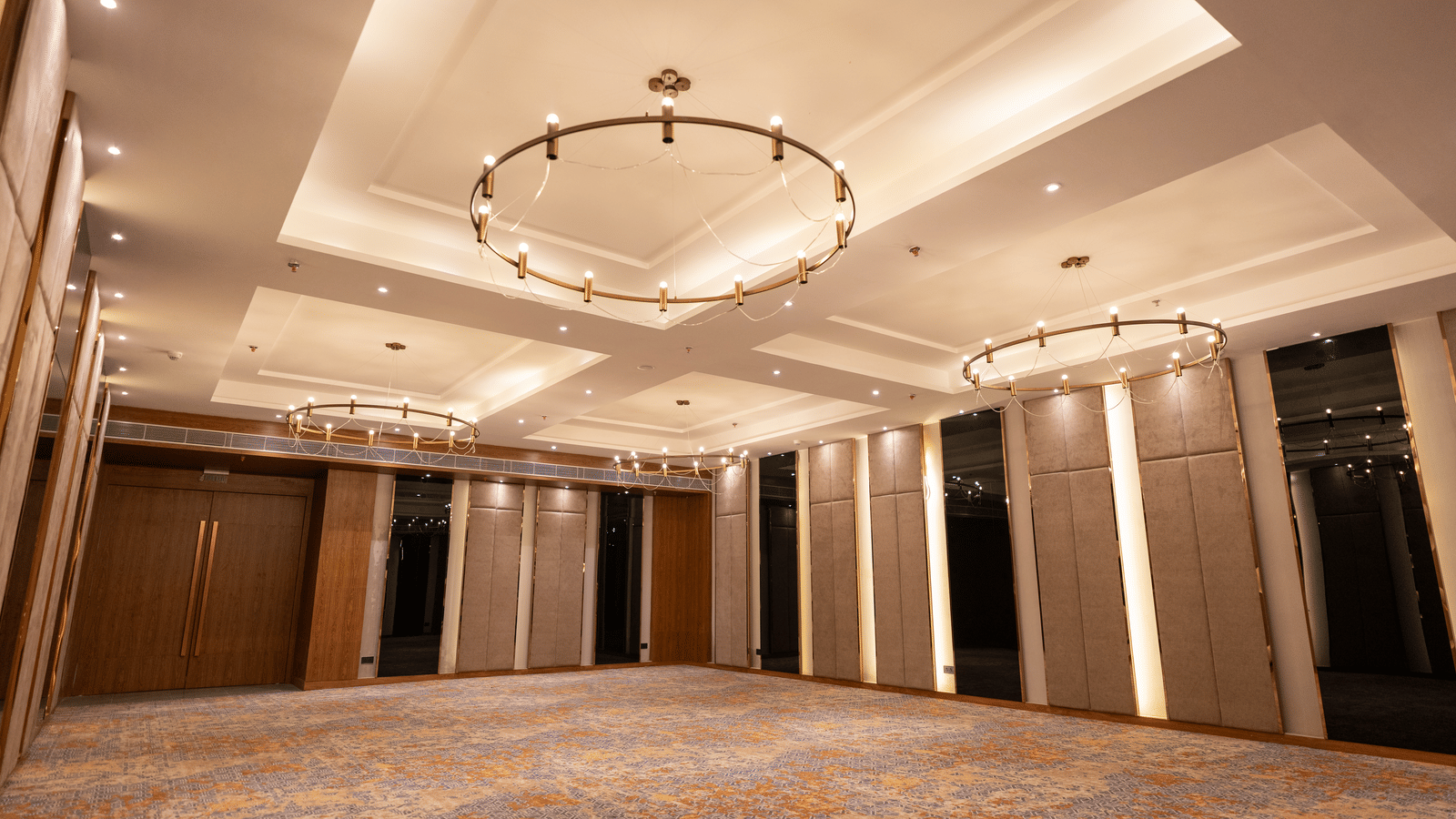 An elegant banquet hall at Wyndham Garden with grand ceiling lights and a wide event layout.