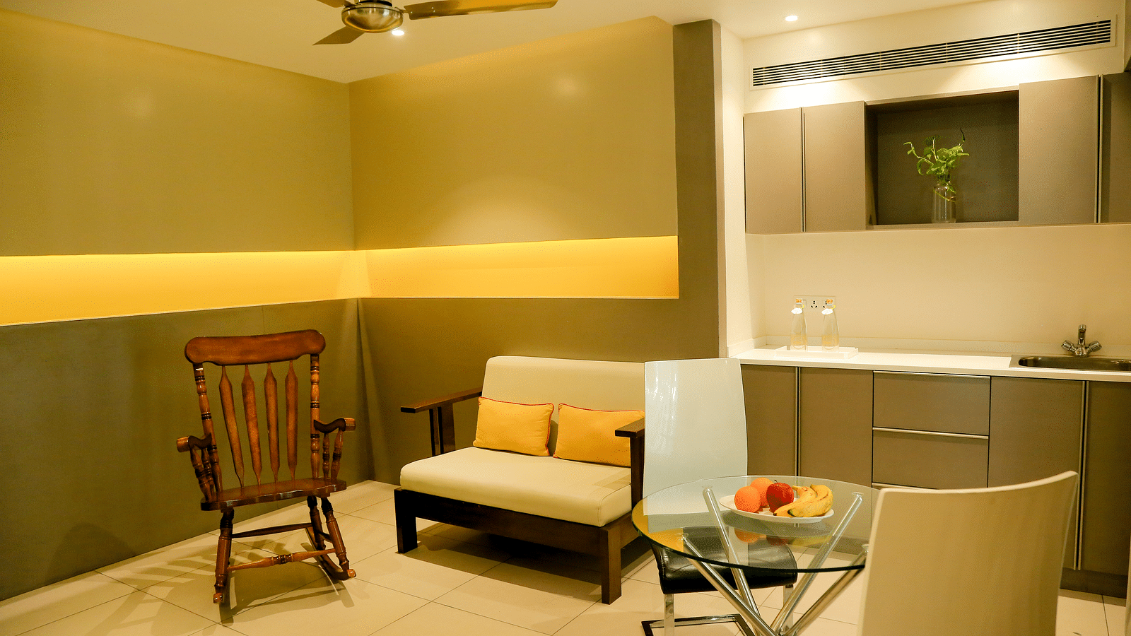 Furniture is arranged around the room, with warm lighting set up to create a cosy atmosphere