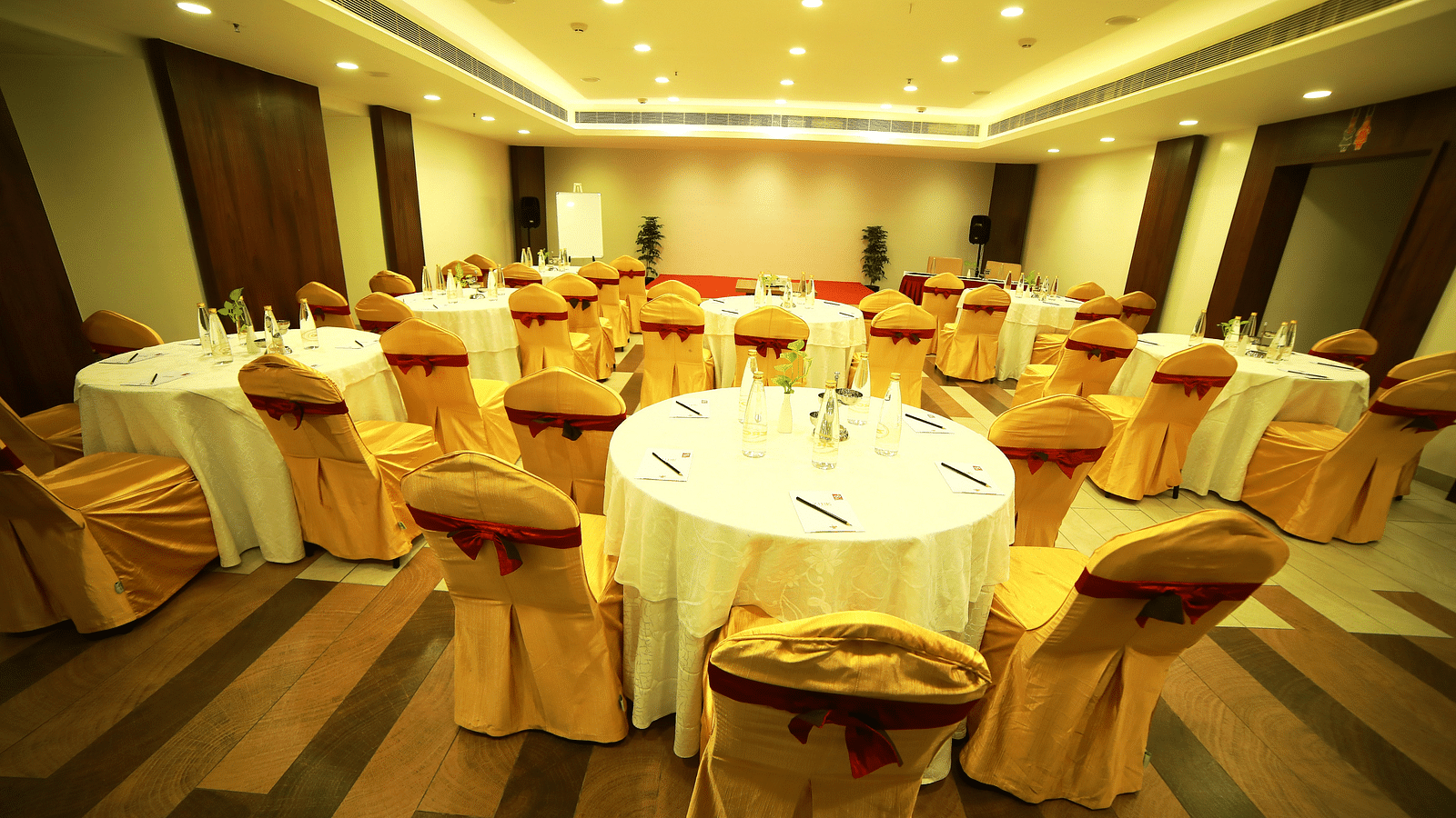 close up view of event hall with elegant ceiling lights illuminating the room at Zibe Salem by GRT Hotels