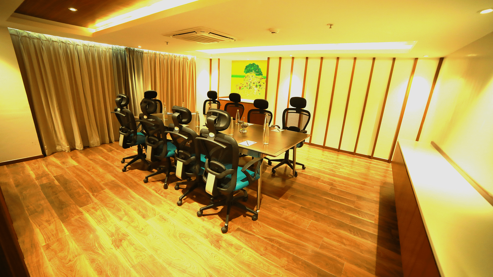 An image of a boardroom with a table and chairs at  Zibe Salem by GRT Hotels