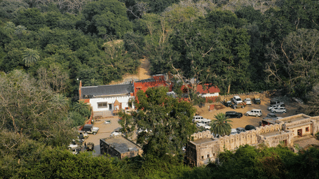 Aerial view of Trinetra Ganesh Temple parking complex surrounded by forest in Ranthambore Fort