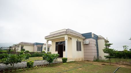 Image of an accommodation with plants in front of it at Aanandam Resort & Spa, Pushkar.