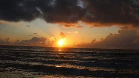 A Golden sunset view from the shore with calm waters