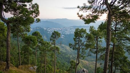 A hill side view of a city nestled between mountains