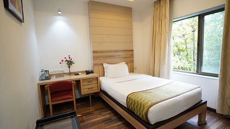 an image of a standard room with a working table and a chair at  City Centre Residency, Bangalore