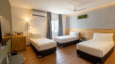 image of a bedroom with wooden flooring at the luxury group stay villa an ideal luxury group accommodation in coimbatore - Darza Resorts