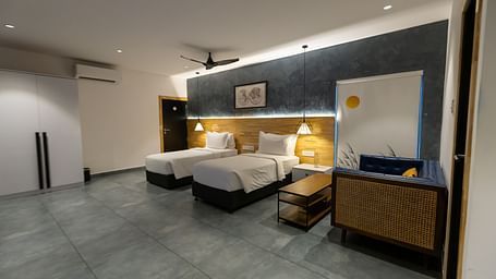 image of a spacious bedroom featuring two twin beds with modern interiors