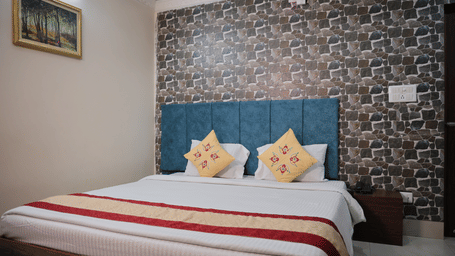 Executive room with a spacious bed, contemporary interiors, and decorative wall finishes.