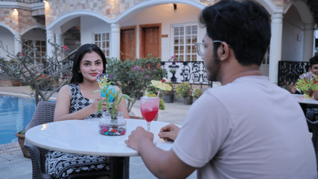 Guests enjoying refreshing beverages during a poolside dining experience at the hotel.