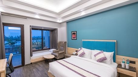 Spacious guest room with large windows and outdoor views - DLS Forest Vines Resort & Spa, Ramnagar (Jim Corbett)