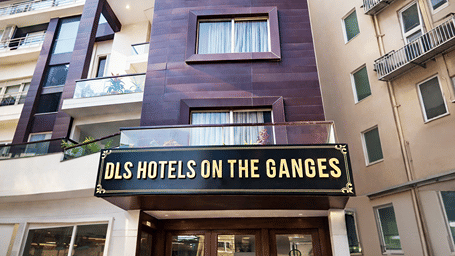 Facade of Dls Hotels on the Ganges, Rishikesh featuring  an entrance of the hotel, several windows from different rooms, and balconies.